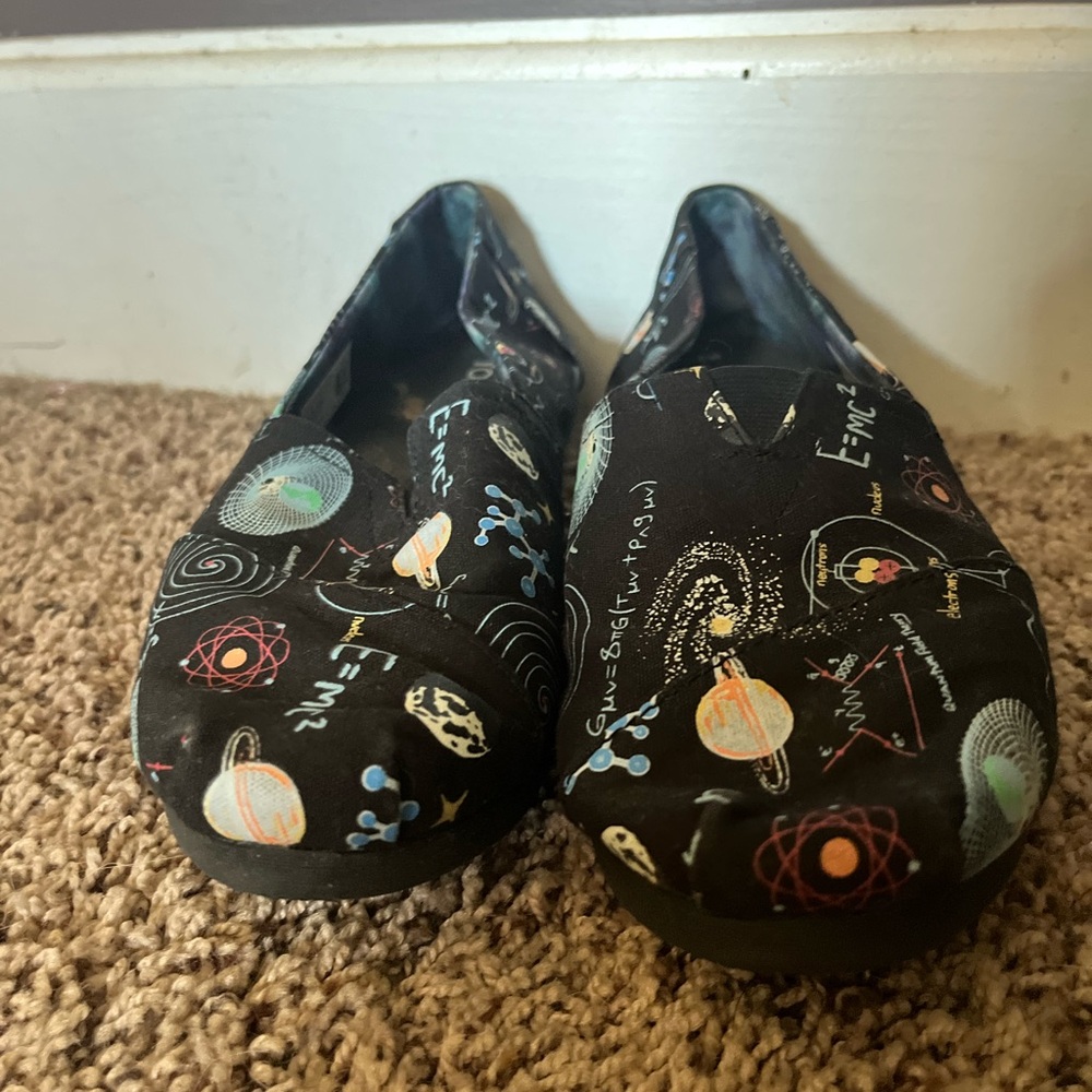 Black Science-Themed Slip-On Toms Shoes